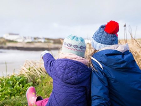 Children sitting on the beach, Anglesey
