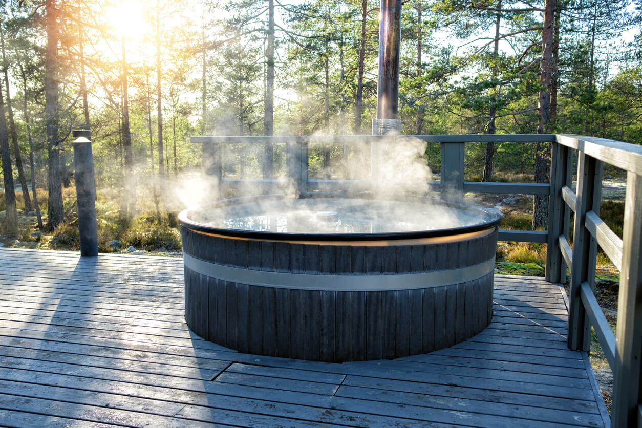 Steamy hot tub outside on decking 