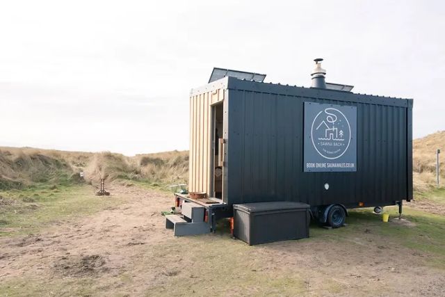 A woodfired sauna on a beach in Anglesey.