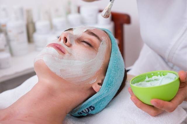 A woman enjoying a facial massage