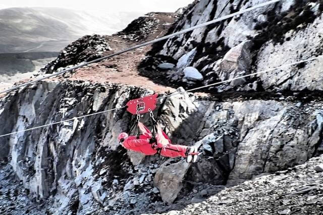 Two people zip-lining at Zip World, Snowdonia