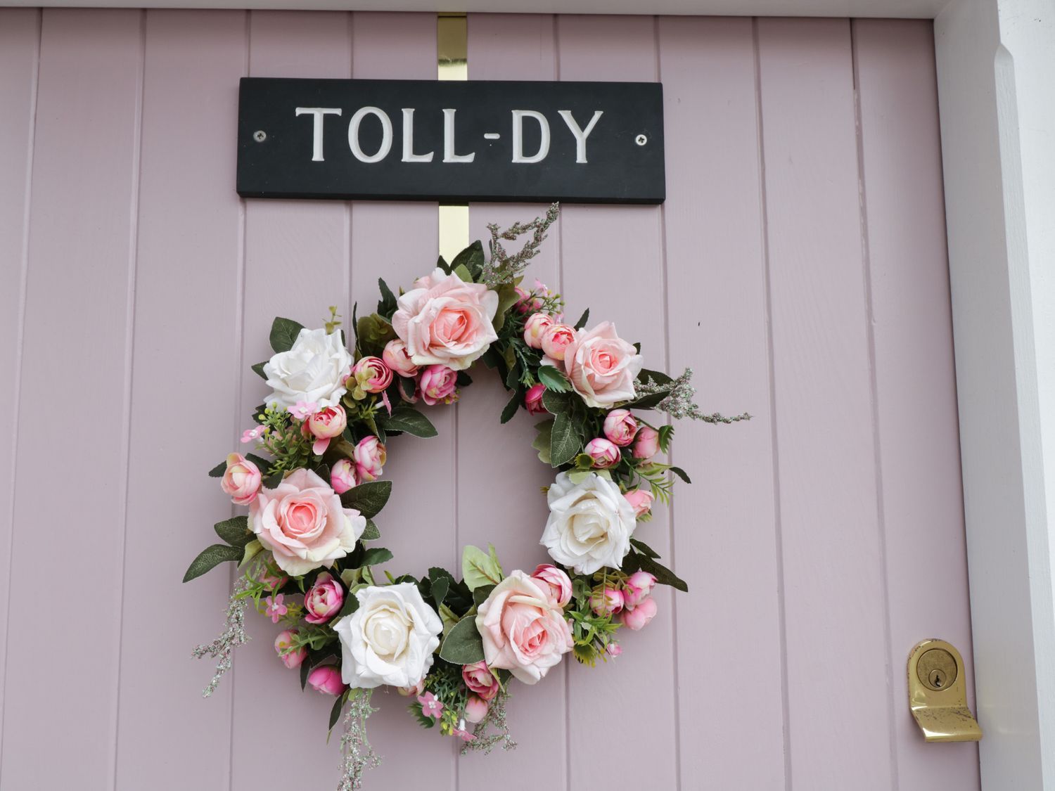 Beautiful wreath on pink door